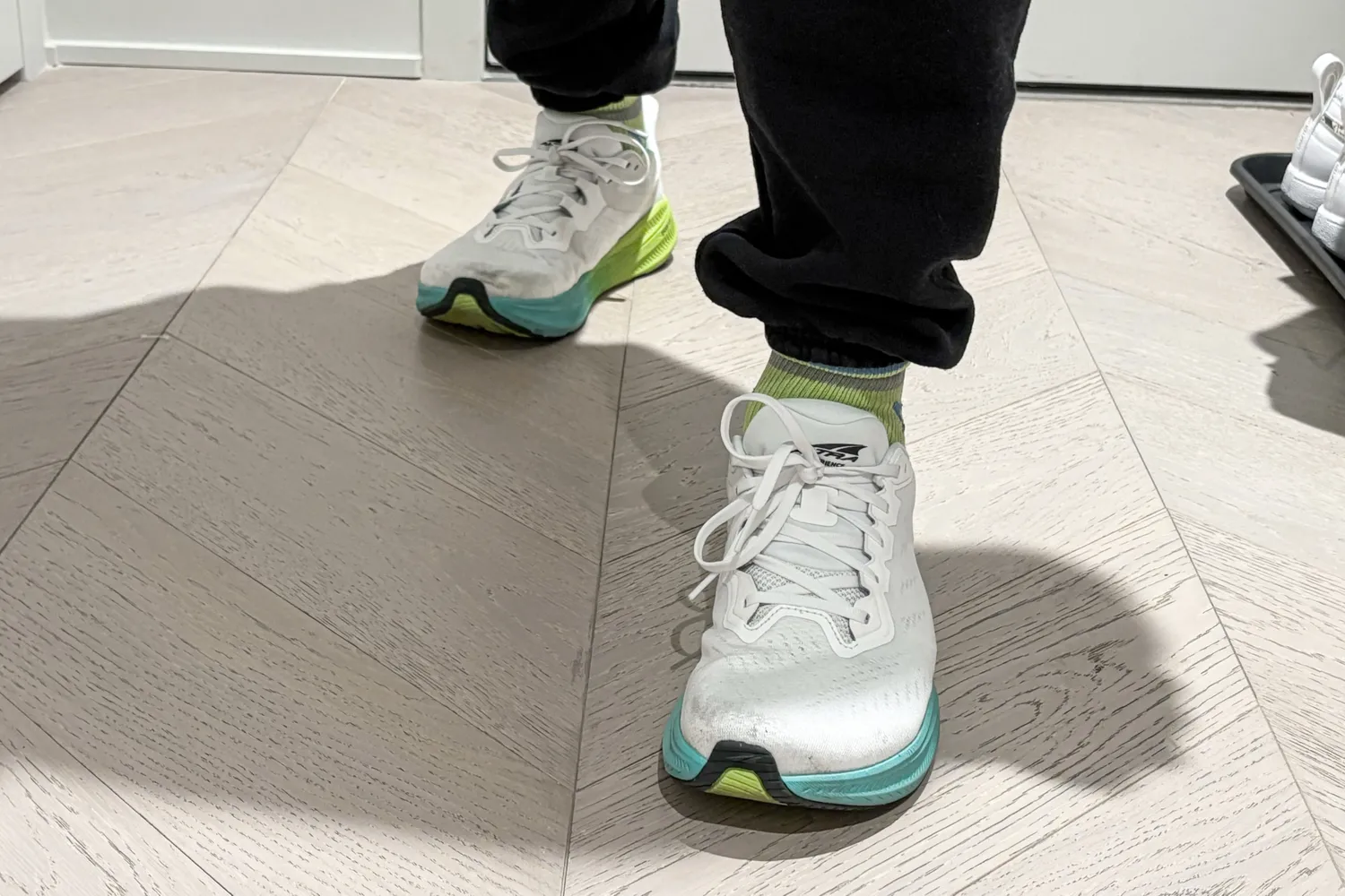 A person wears the Altra Men's Experience Flow 2 Sneakers