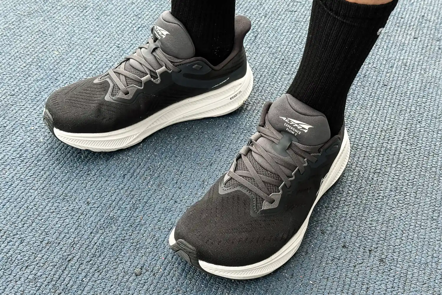 A person wears the Altra Men's Experience Flow 2 Sneakers with black socks