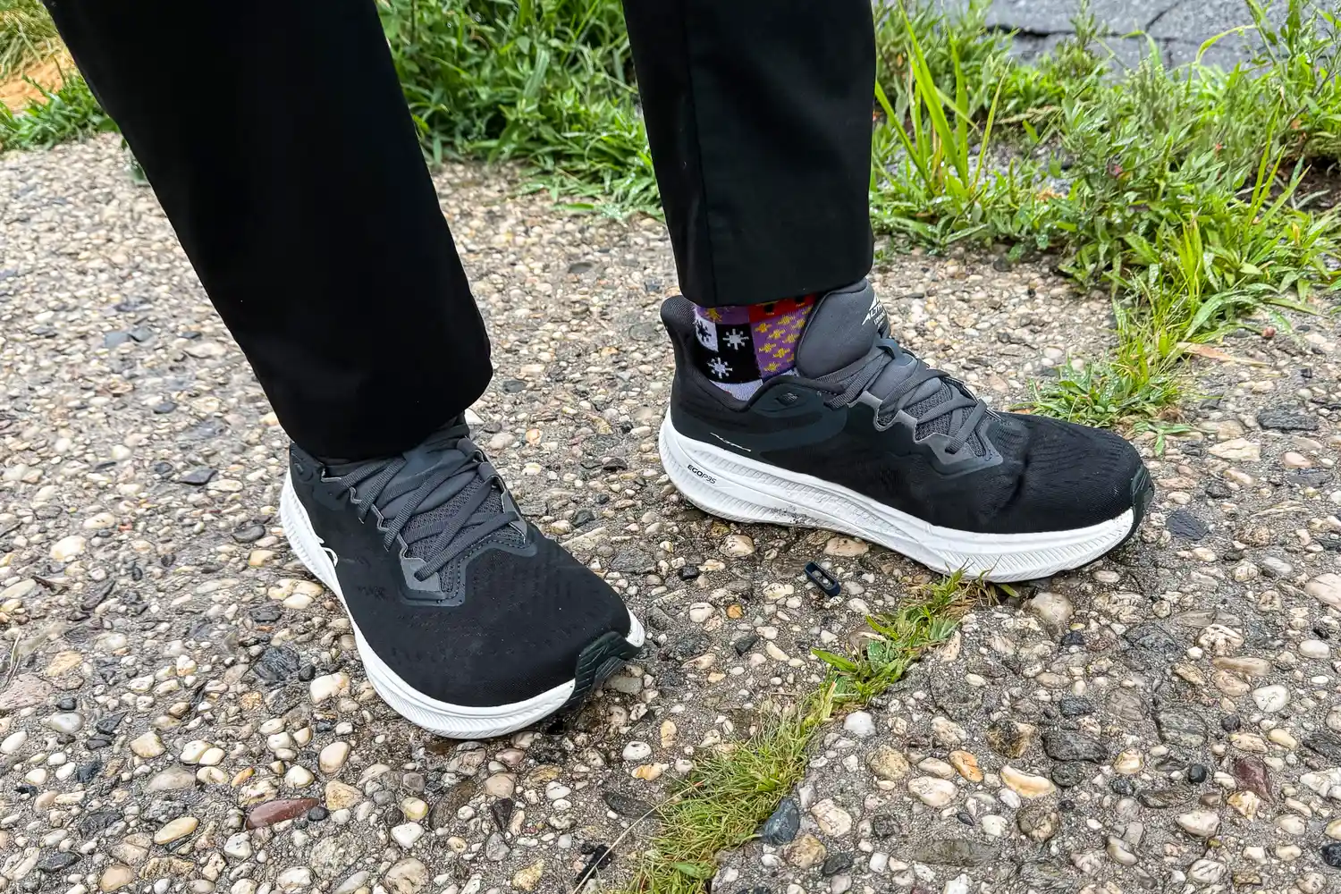 A person wears the Altra Men's Experience Flow 2 Sneakers while walking outside
