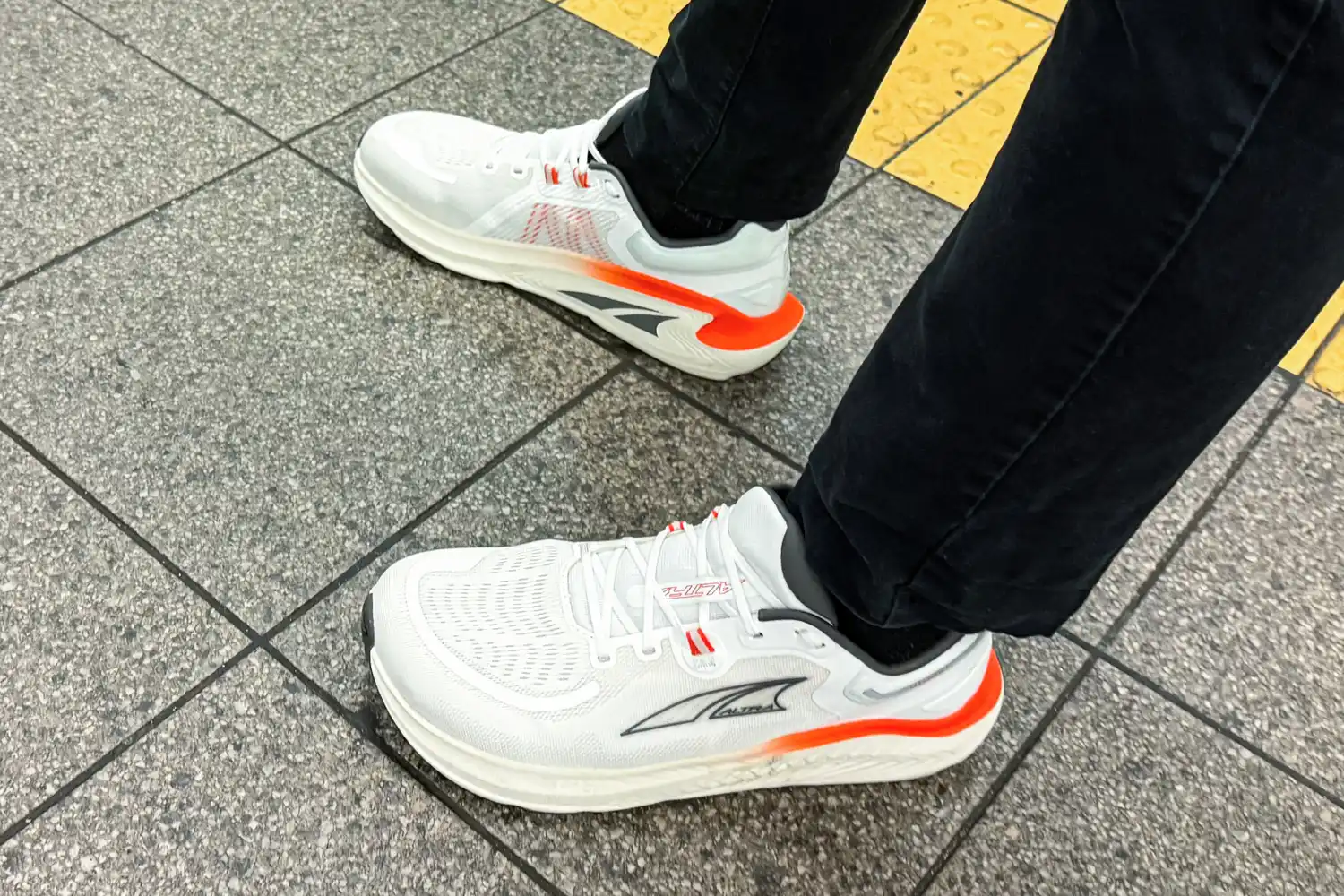 A person's feet wearing Altra Men's Paradigm 7 Sneakers
