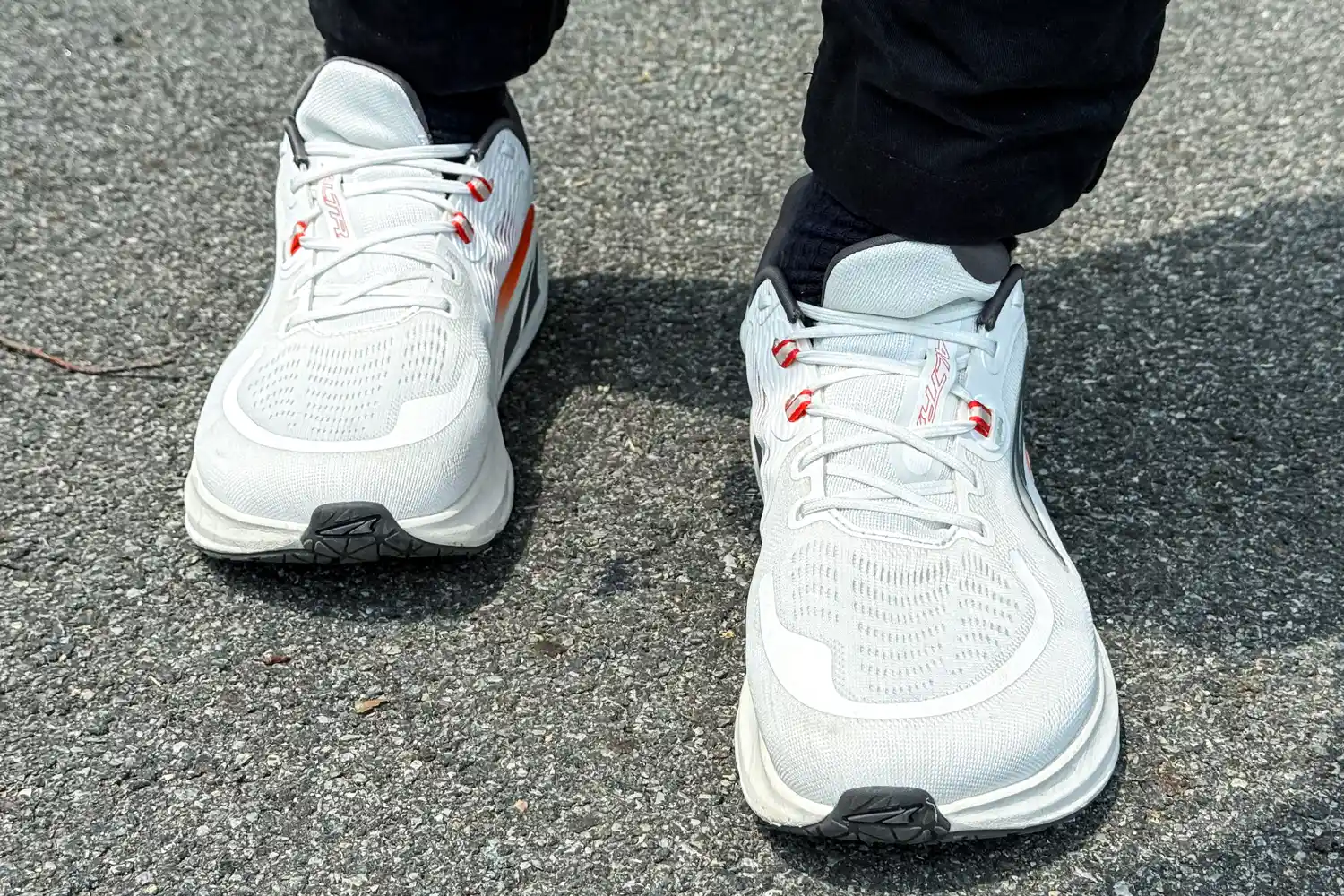 A front view of a person wearing the Altra Men's Paradigm 7 Sneakers while walking outside