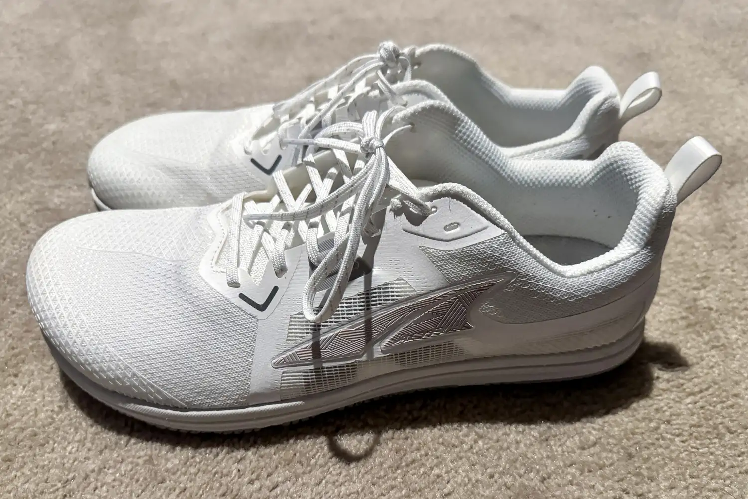 The Altra Men's Solstice XT 3 sneakers posed to the side on a carpet