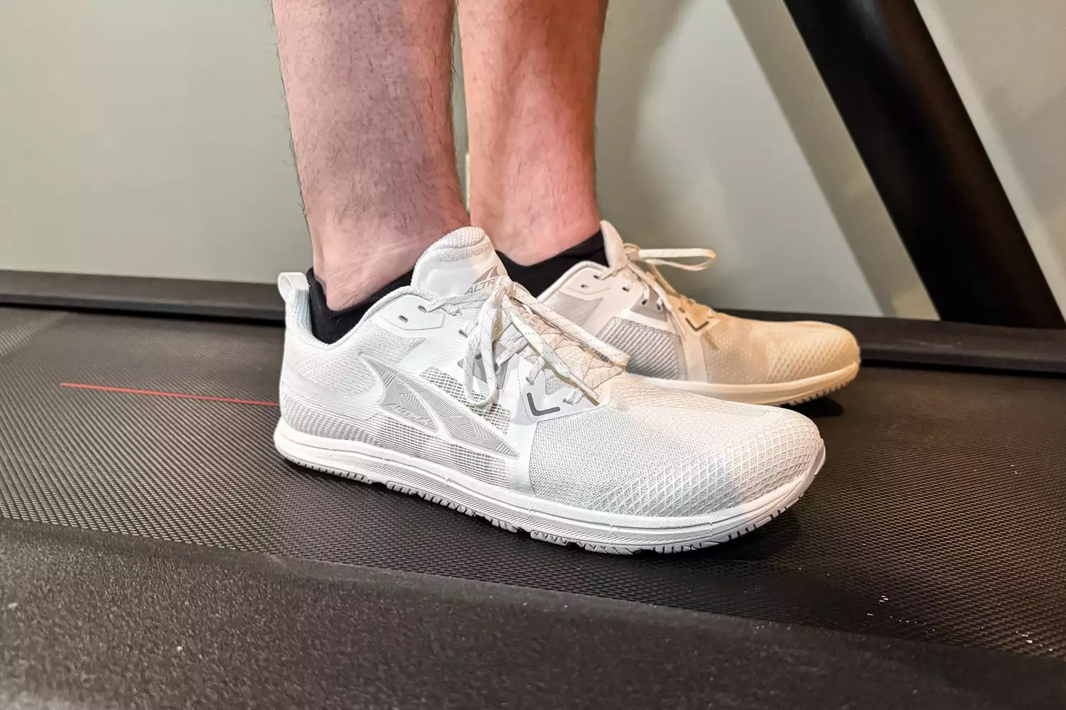 Two feet posed from the side on a treadmill while wearing the Altra Men's Solstice XT 3