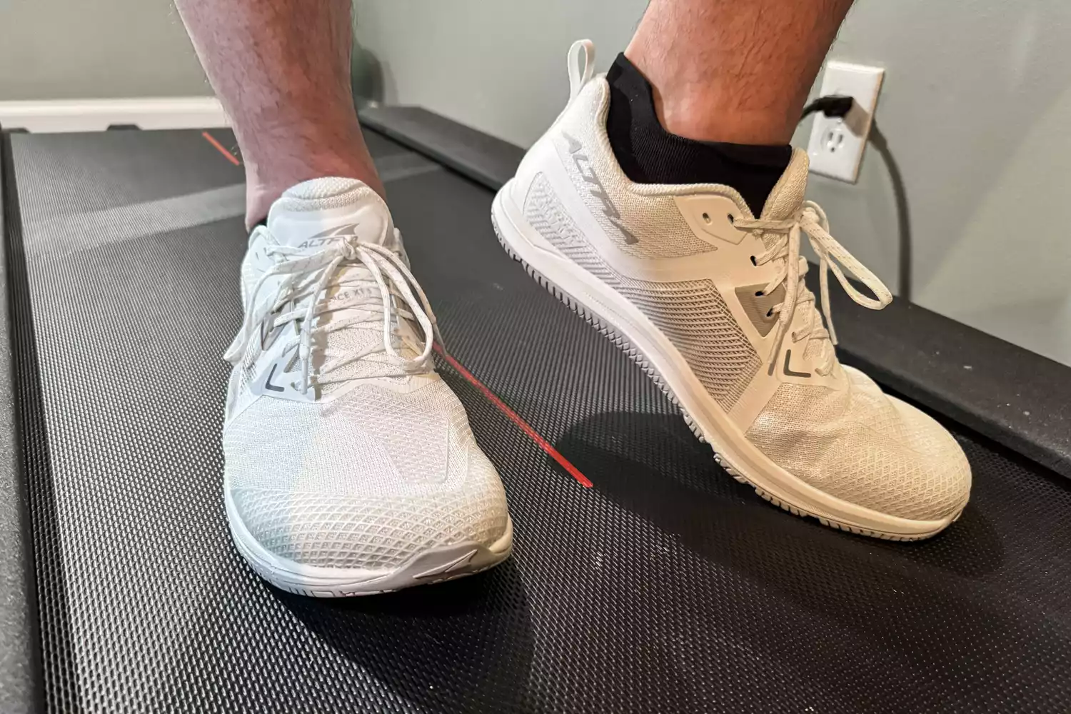 A close-up of the Altra Men's Solstice XT 3 sneakers worn on a treadmill