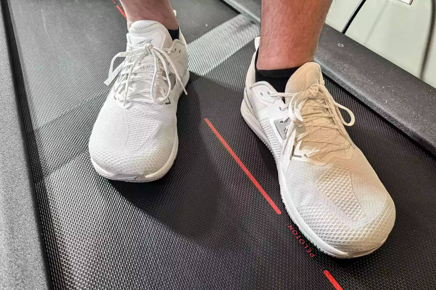 A close-up of two feet wearing the Altra Men's Solstice XT 3 on a treadmill