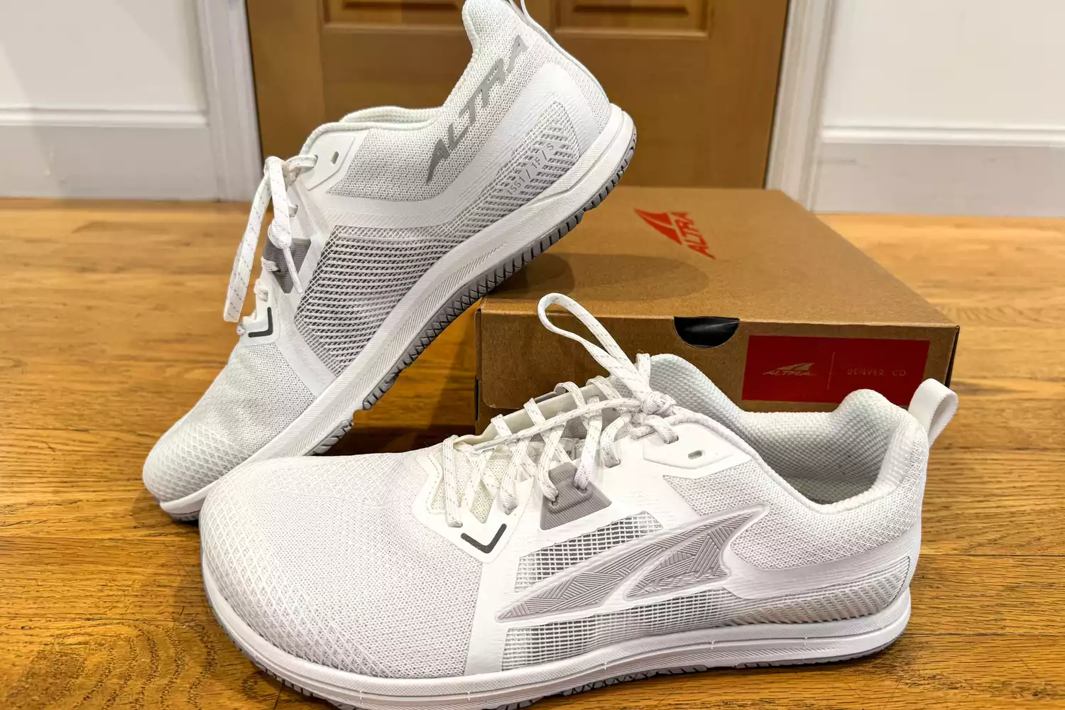 The Altra Men's Solstice XT 3 sneakers posed around their box