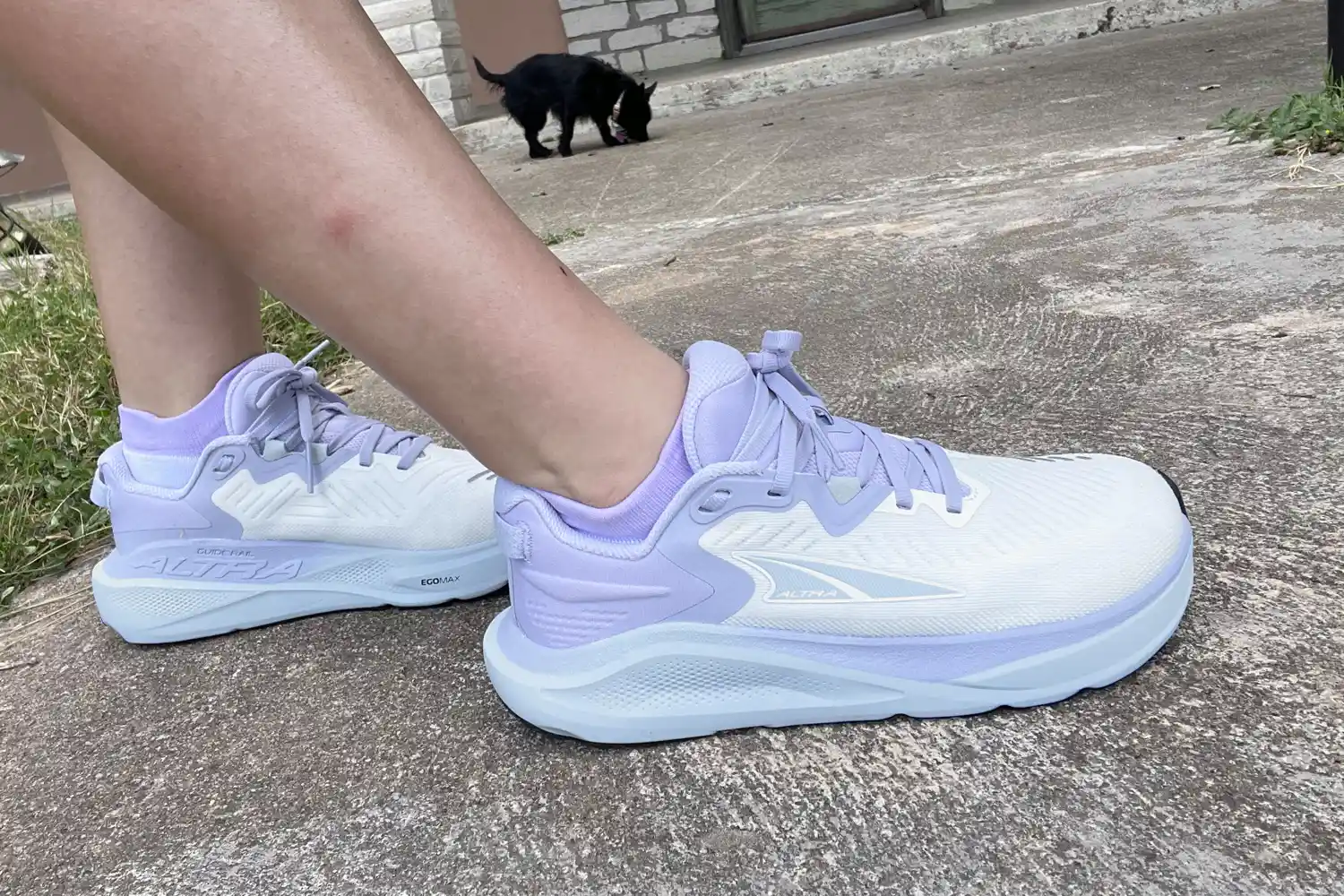 A side view of a person wearing the Altra Women's Paradigm 8 Running Shoes