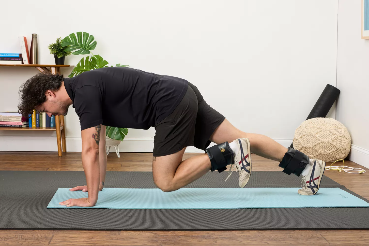 A person does mountain climbers while wearing the The Cuff Original Adjustable Ankle and Wrist Weights
