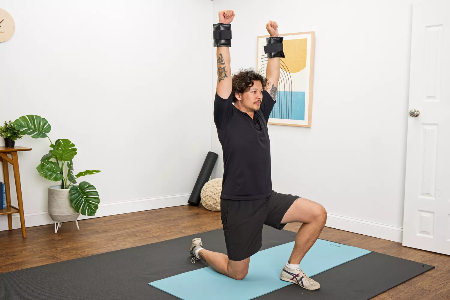 A person lifts their arms while wearing the The Cuff Original Adjustable Ankle and Wrist Weights