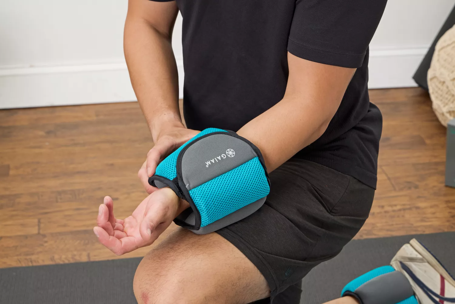 A person wears the Gaiam Fitness Ankle Weight on their arm