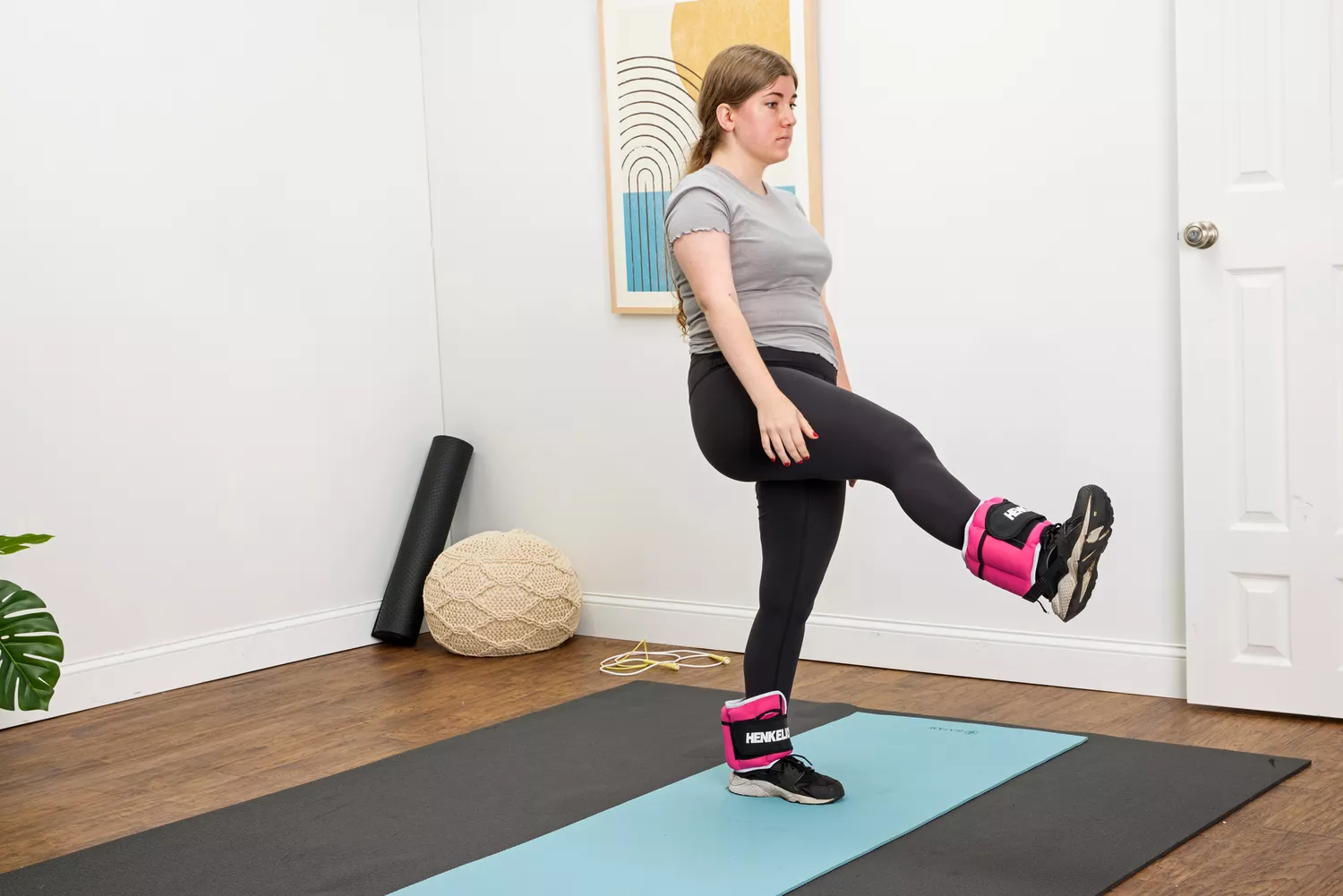 A person lifts their leg while wearing the Henkelion Adjustable Ankle Weights