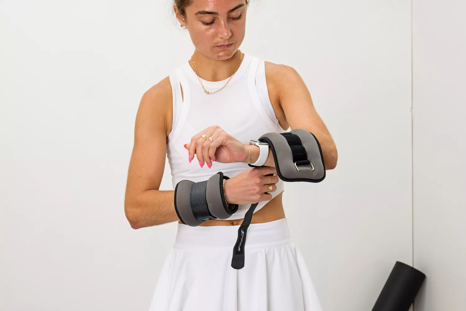 A person attaches the ProsourceFit Ankle/Wrist and Arm/Leg Weights to their forearms