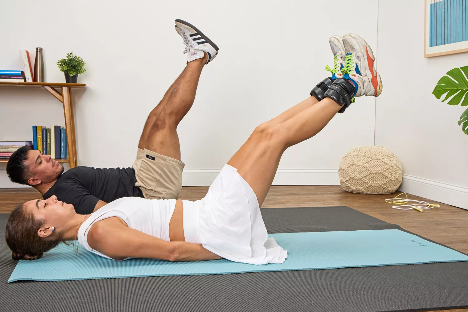 A person does leg lifts while wearing the Tracy Anderson UWRAPS Vegan Leather Ankle/Wrist Weights