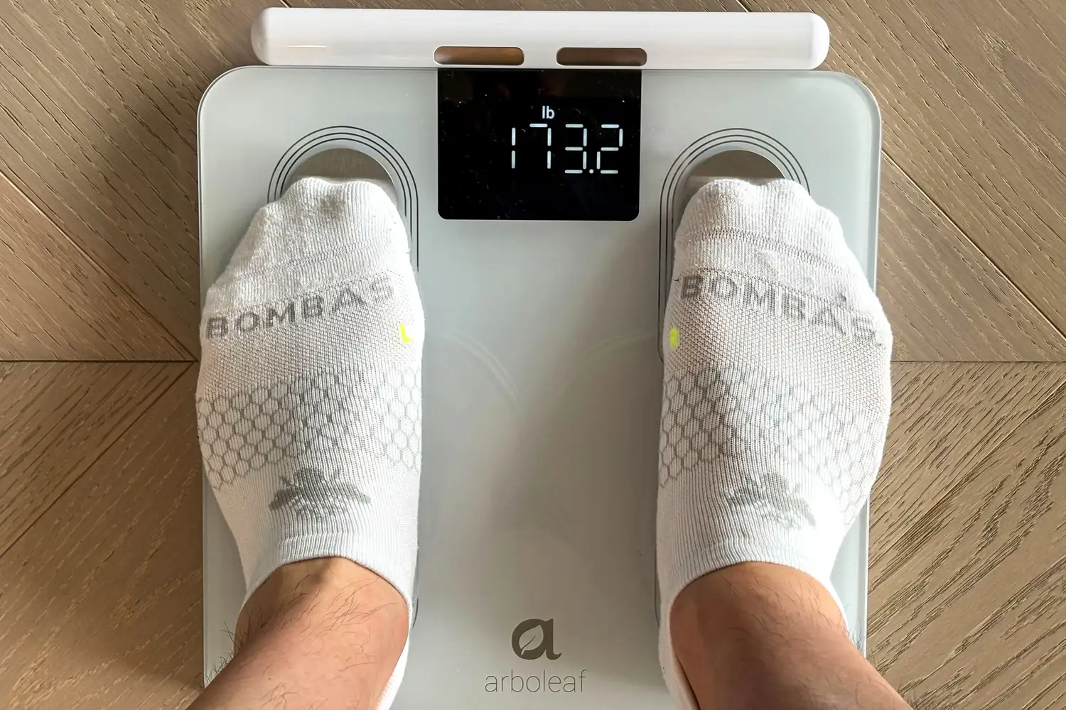 A person stands on the Arboleaf CS10E Segmental Body Scale