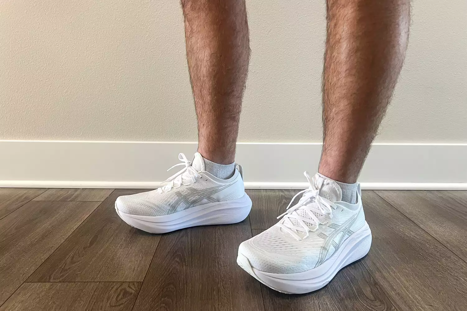 A person's legs close-up while wearing the Asics Men's GEL-NIMBUS 27