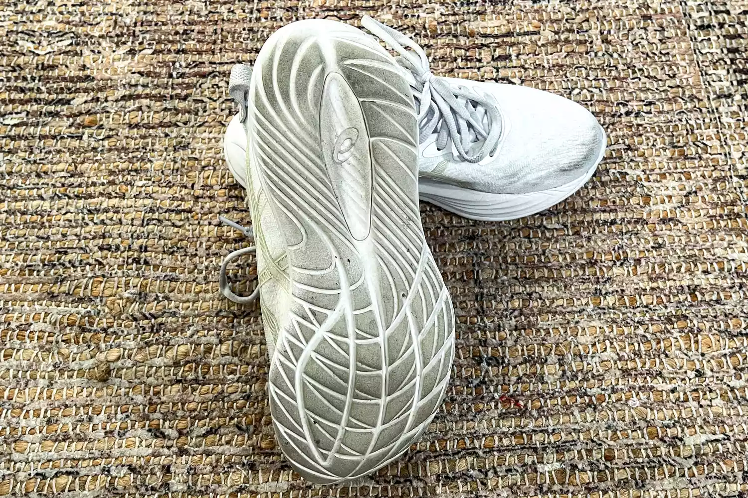 The treads on the bottom of the Asics Women's Gel-Cumulus 27 Running Shoes after use