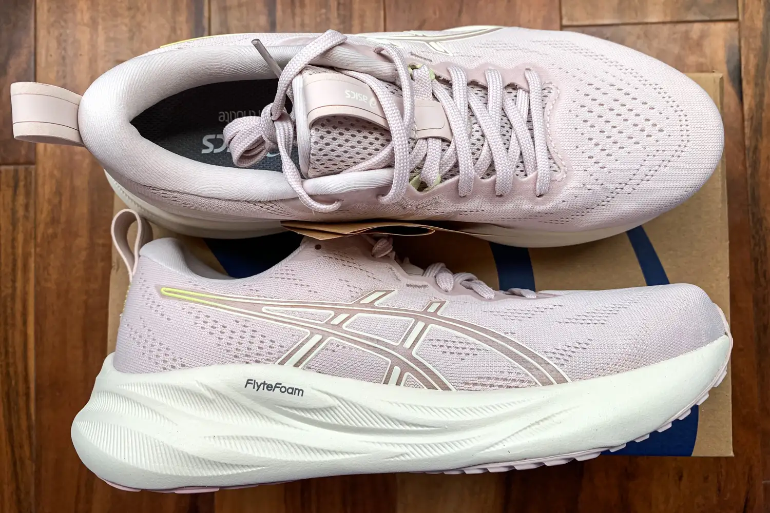 The Asics Women's GEL-Pulse 16 sneakers posed on top of their box