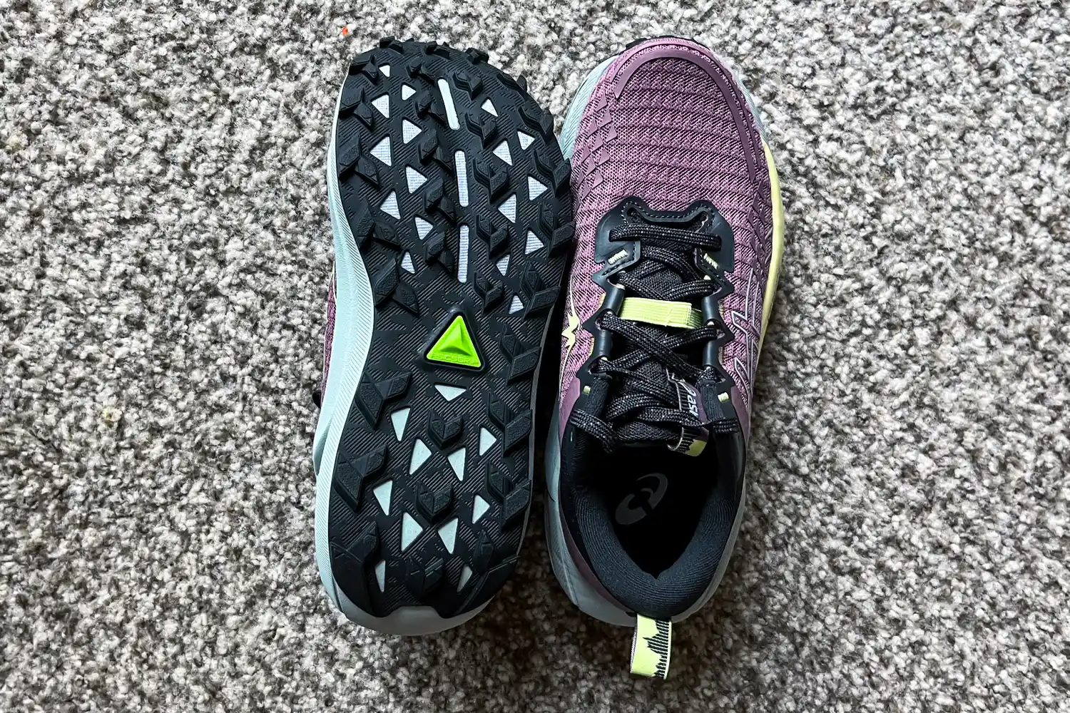 A pair of Asics Women's Gel-Trabuco 13 Trail Running Sneakers on carpet