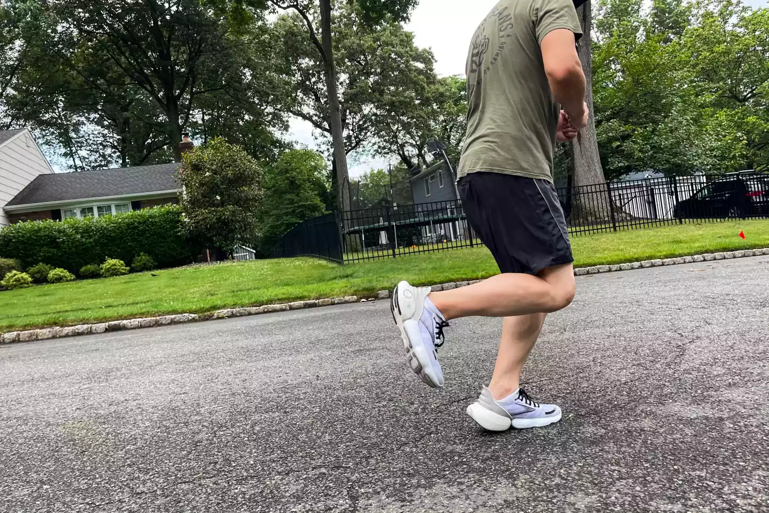 A person running while wearing Brooks Aurora BL sneakers outdoors