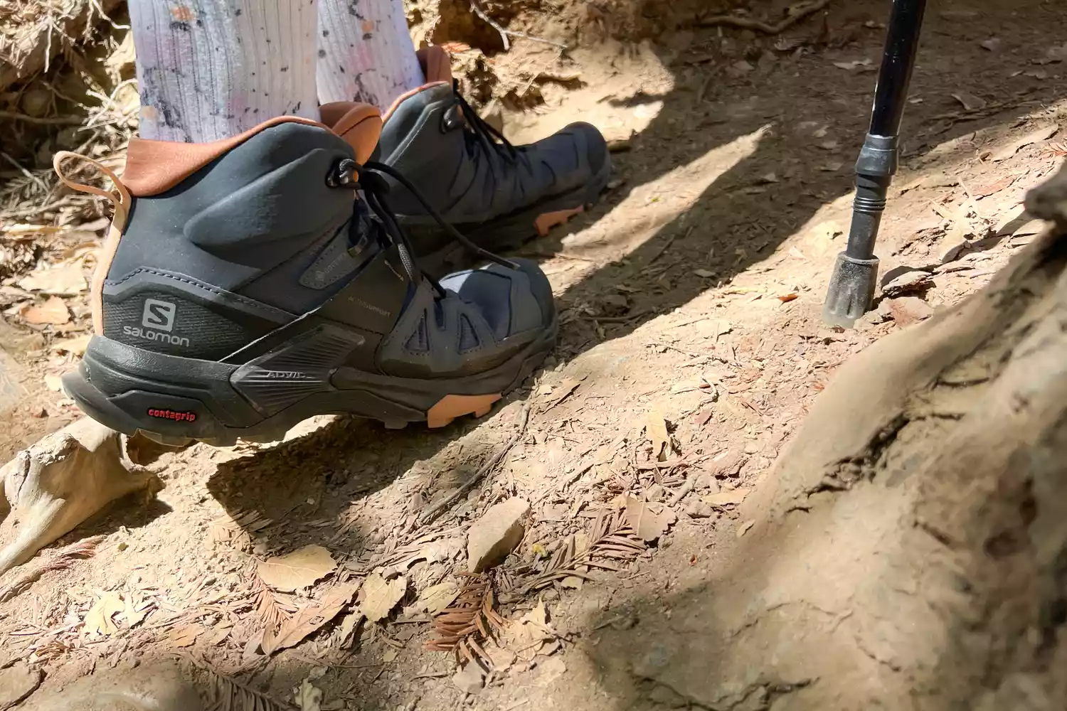 Feet wearing Salomon X Ultra 4 Mid Gore-tex Boots on a dirt trail