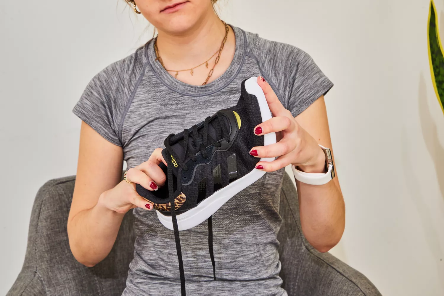 Person holding an Adidas Women's Cloudfoam Qt Racer Running Shoe