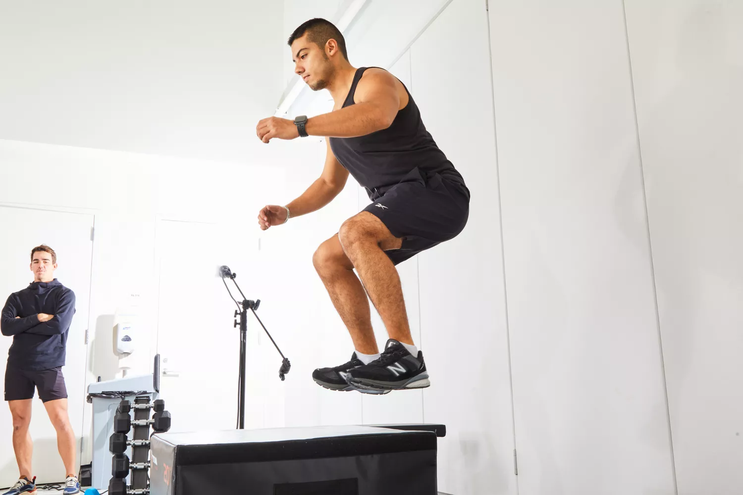 Person jumping on box wearing New Balance Men’s M990v5 Running Shoes