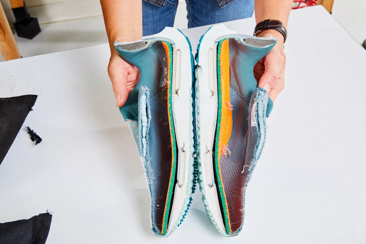 Person holding halves of Nike Women's Pegasus 39