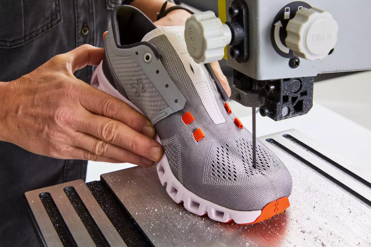 Person cutting On Running Women's Cloud X Running Shoe in half