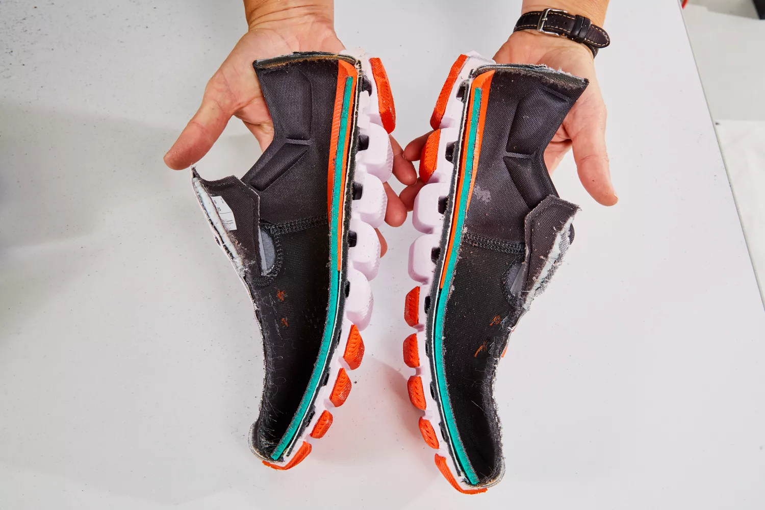 Person holding halves of On Running Women's Cloud X Running Shoe