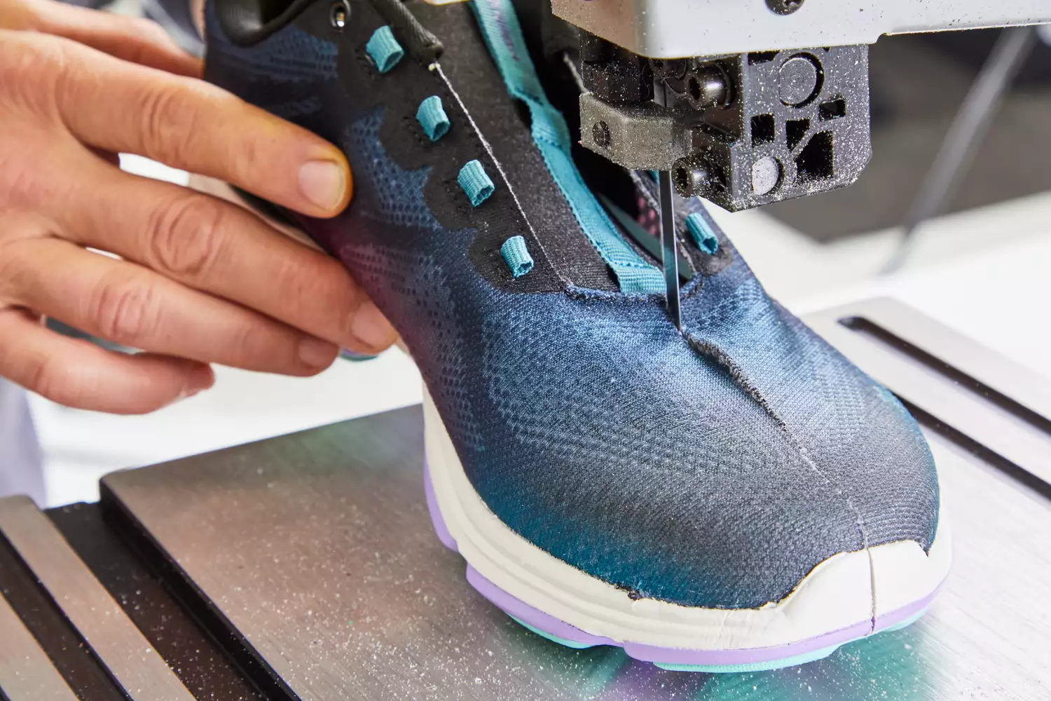 Person cutting Ryka Women's Devotion Plus 4 Walking Shoe in half