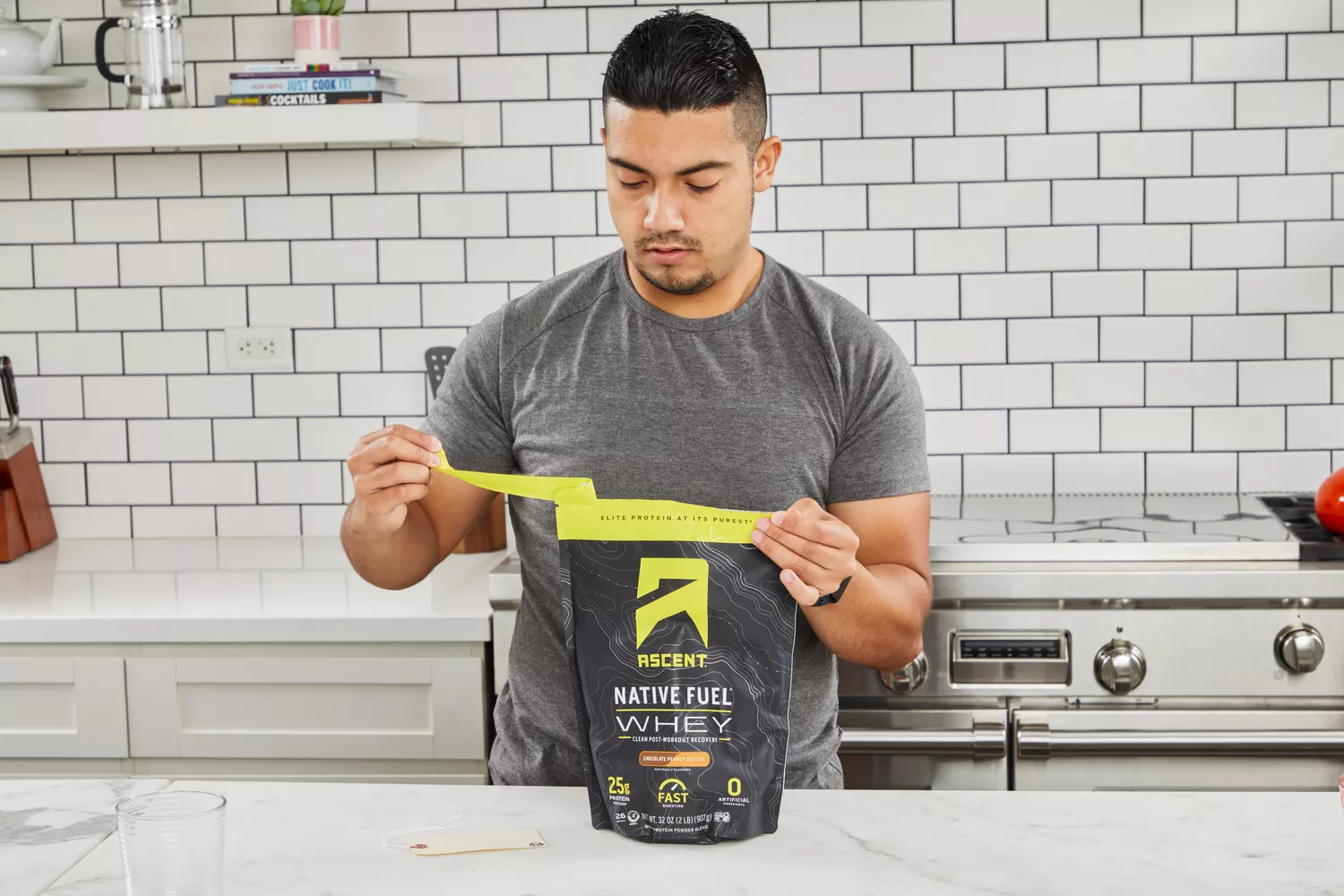 Person opening a package of Ascent Native Fuel Whey Protein Powder