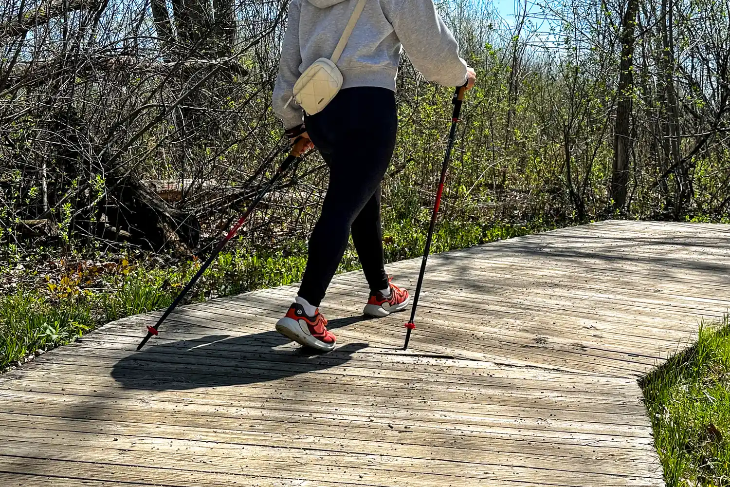 A person walks outside while using the Black Diamond Pursuit Carbon Z Poles