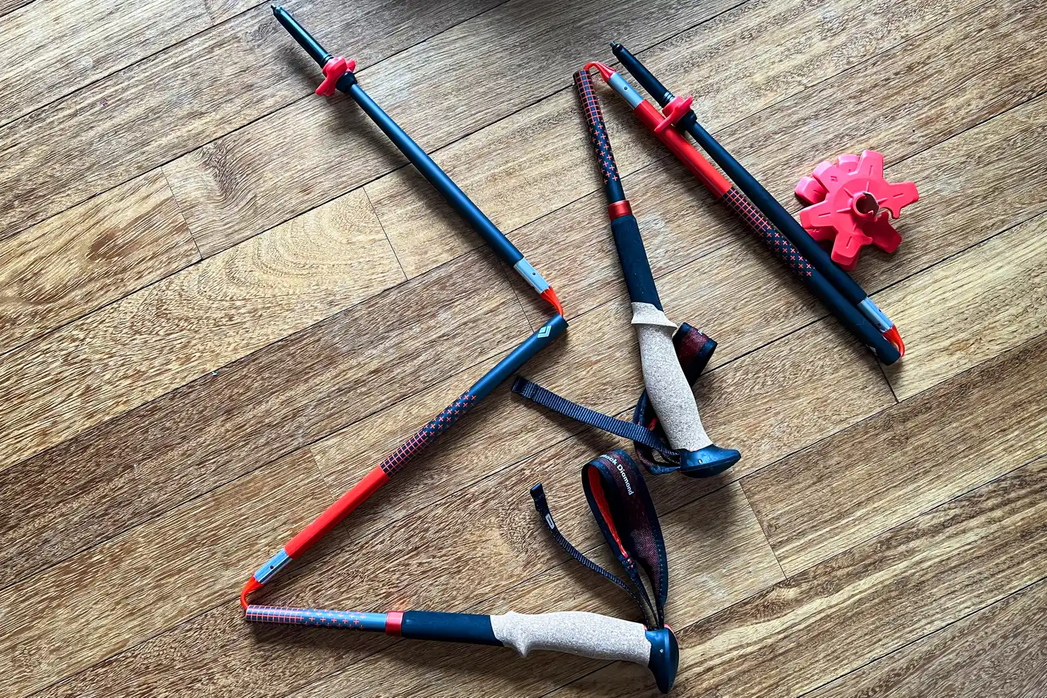 The Black Diamond Pursuit Carbon Z Poles collapsed on a wooden floor
