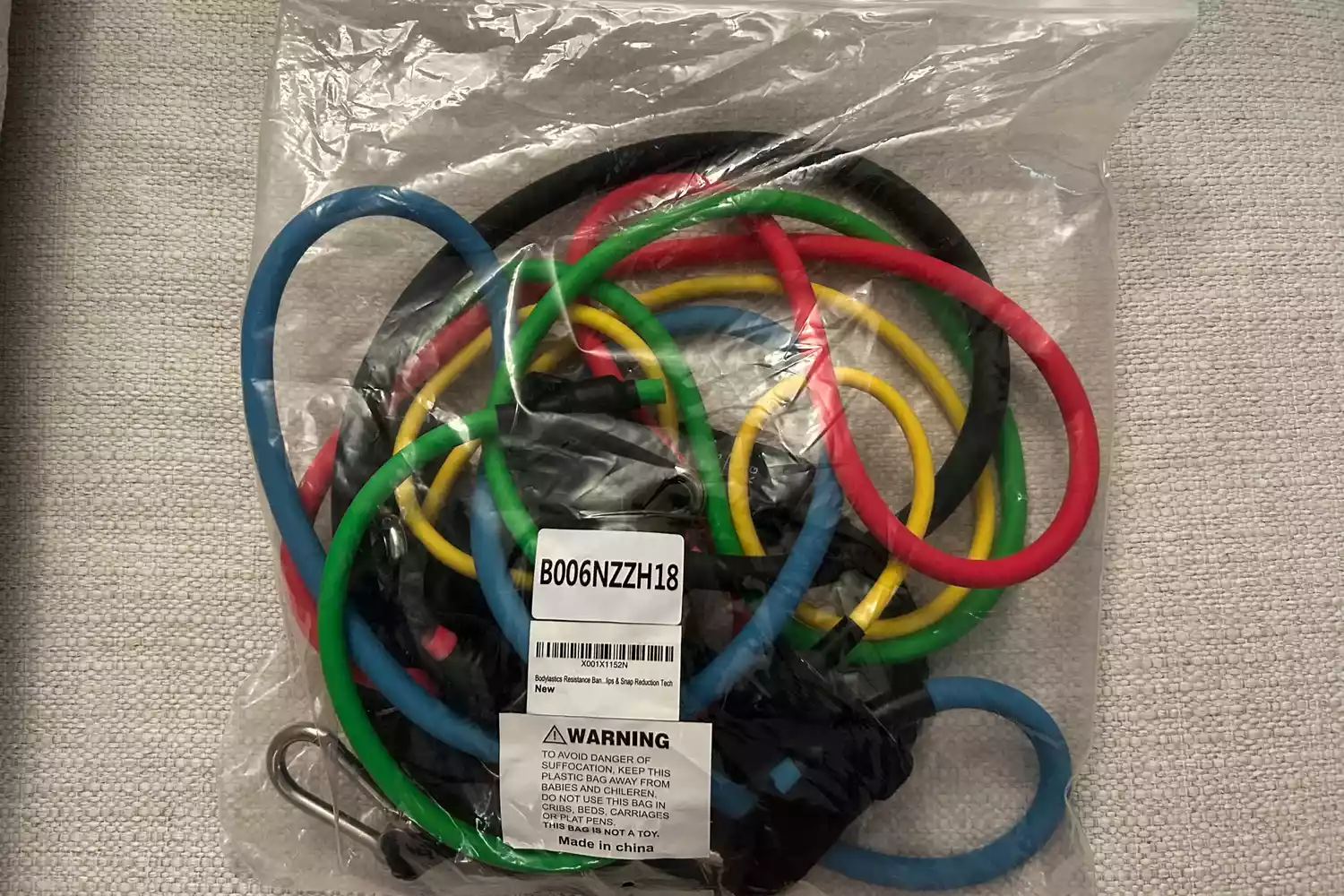 The Bodylastics Resistance Band Set in their original packaging on a fabric surface