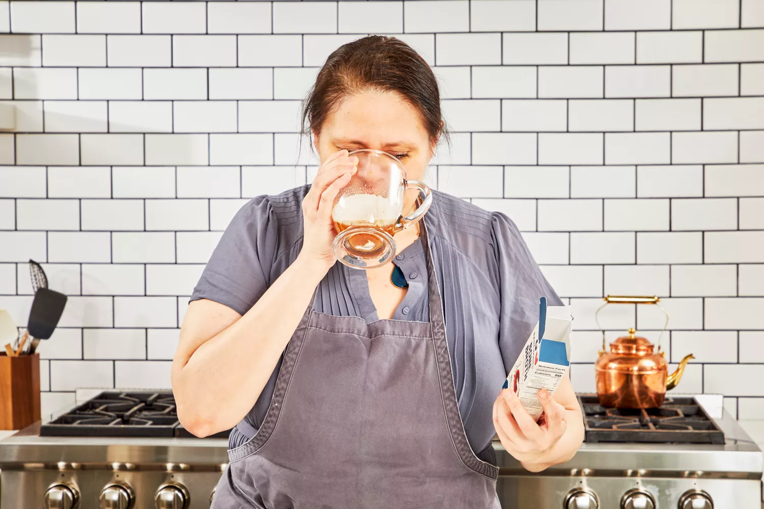 A person drinks a glass of Bare Bones Bone Broth Instant Powdered Beverage Mix