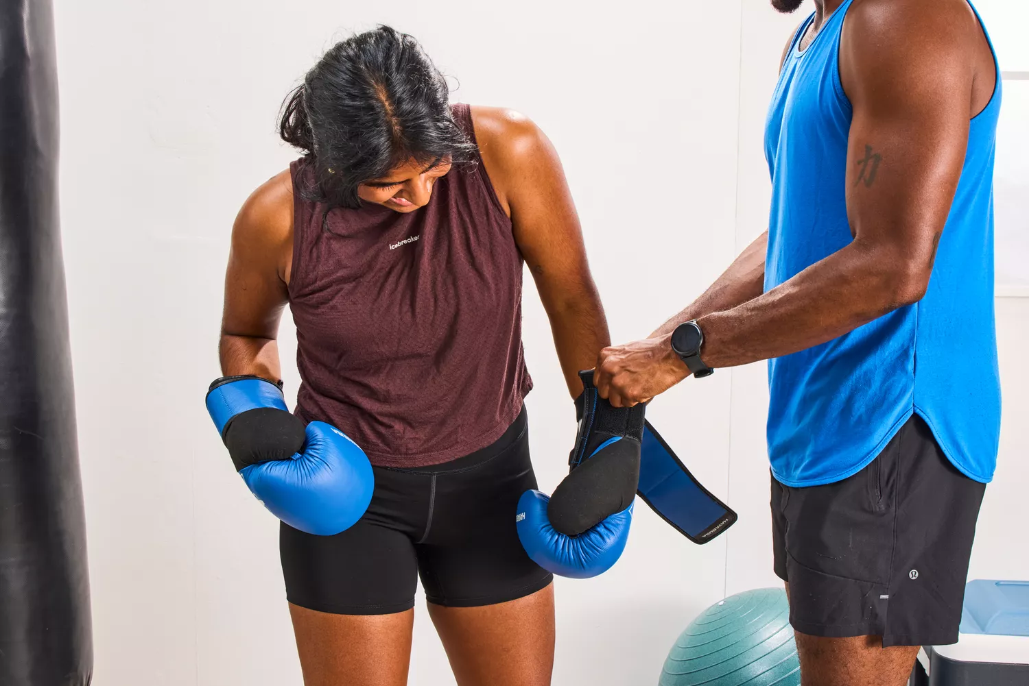 A person adjusts the Hayabusa S4 Leather Boxing Gloves