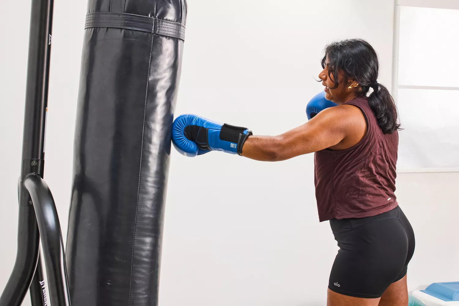 A person uses the Hayabusa S4 Leather Boxing Gloves to punch a bag