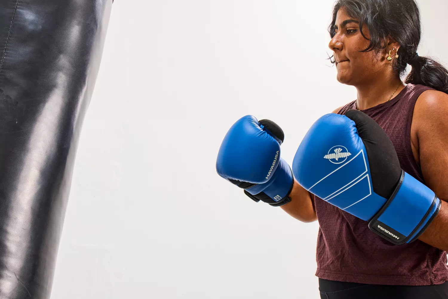 A person wears the Hayabusa S4 Leather Boxing Gloves during exercise