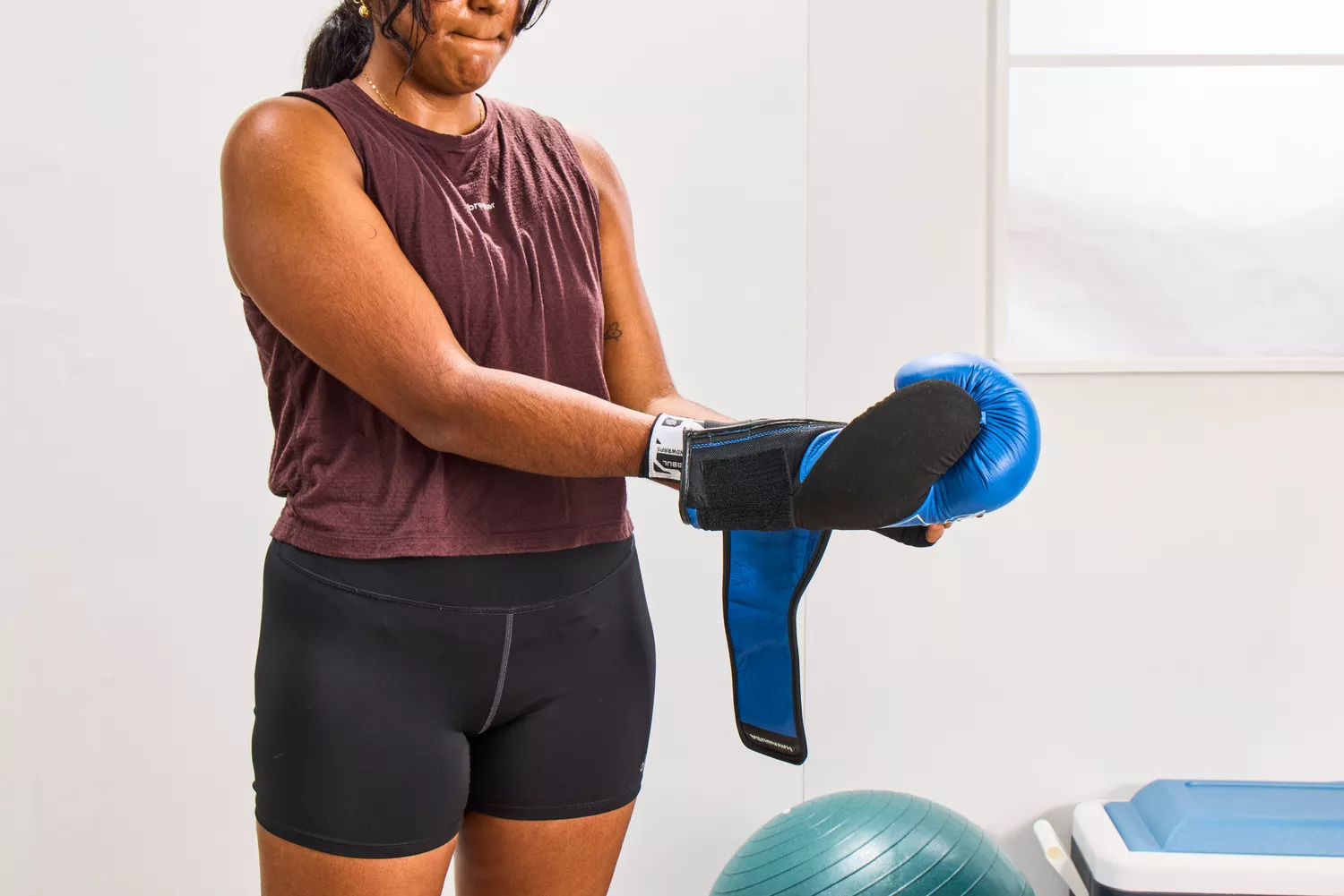 A person places their hand in the Hayabusa S4 Leather Boxing Gloves