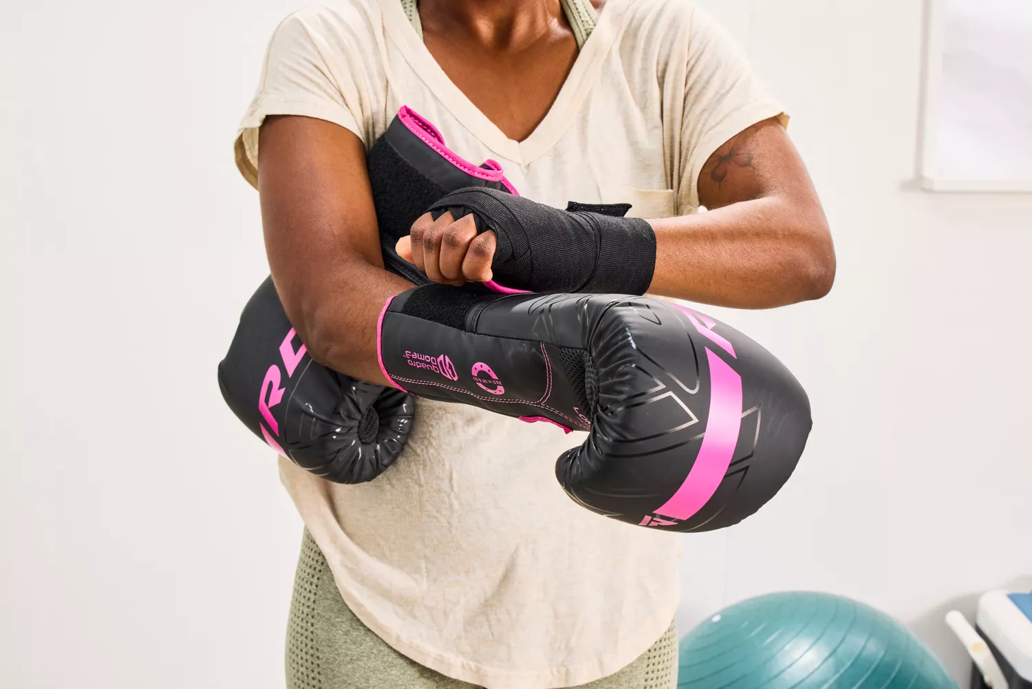 A person secures the RDX Boxing Gloves on their hands