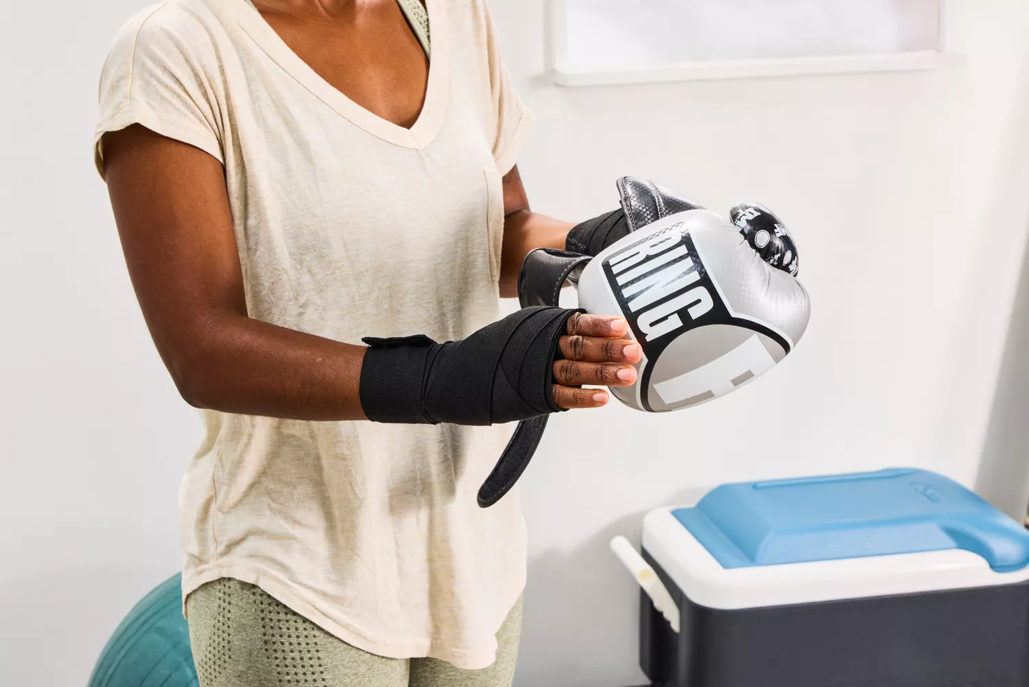 A person prepares to put on the Ringside Apex Flash Sparring Gloves