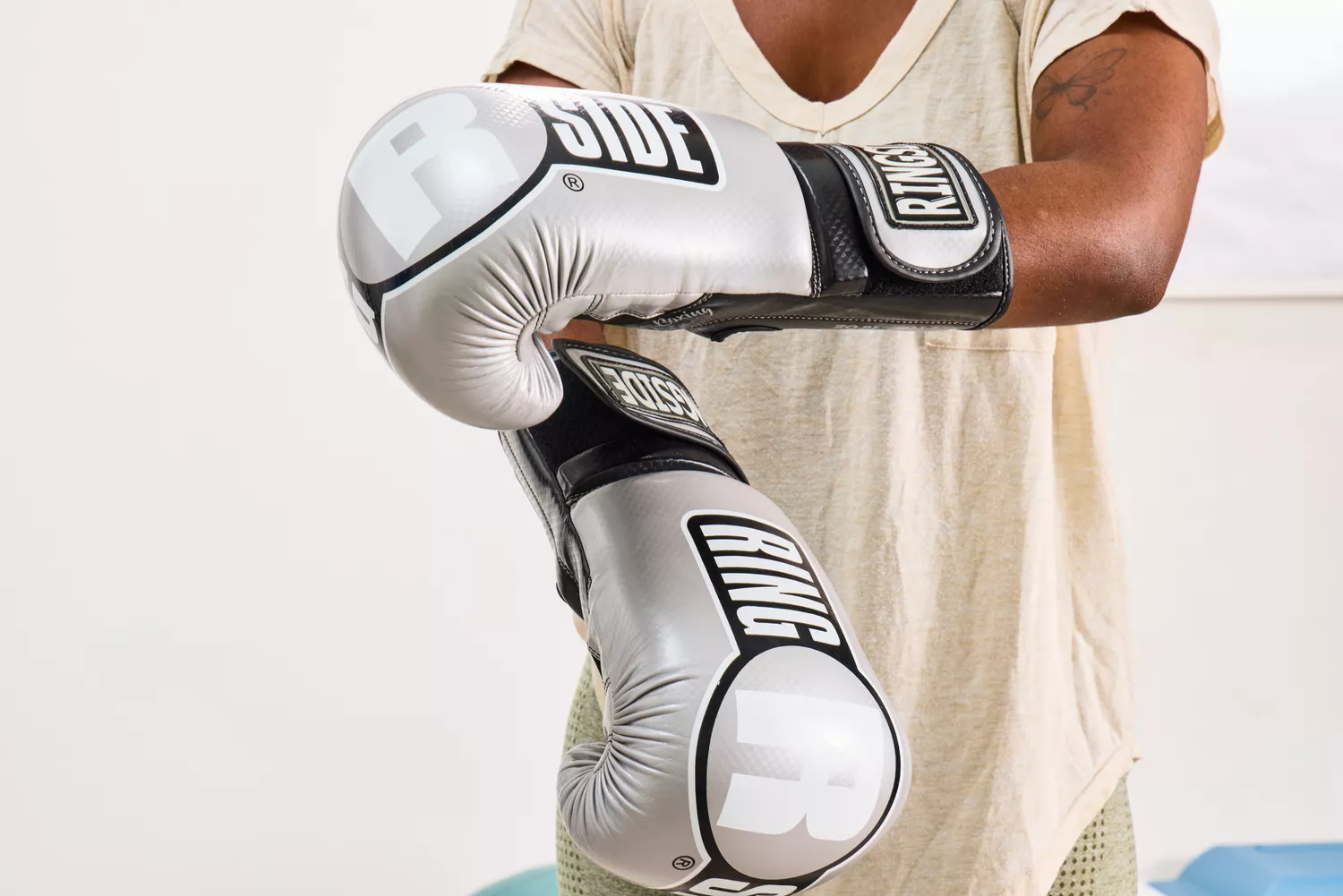A person puts on the Ringside Apex Flash Sparring Gloves