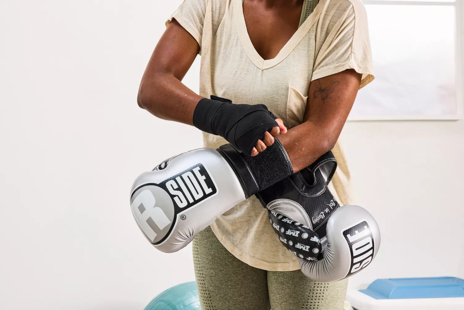 A person secures the Ringside Apex Flash Sparring Gloves onto their hands