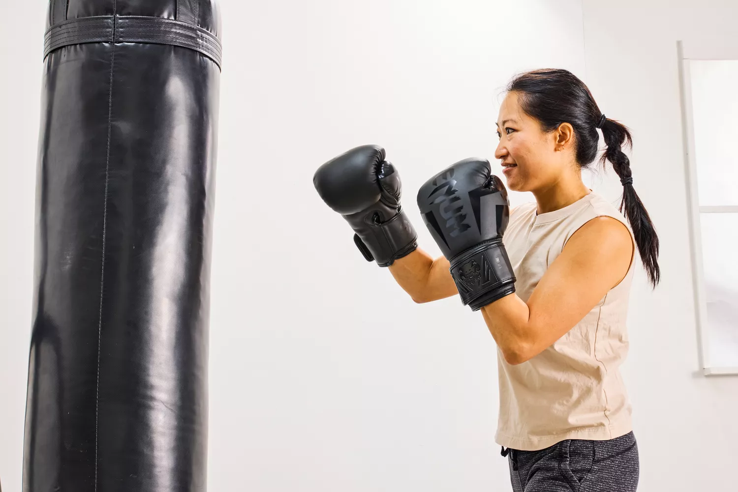 A person wears the Venum Elite Boxing Gloves during exercise