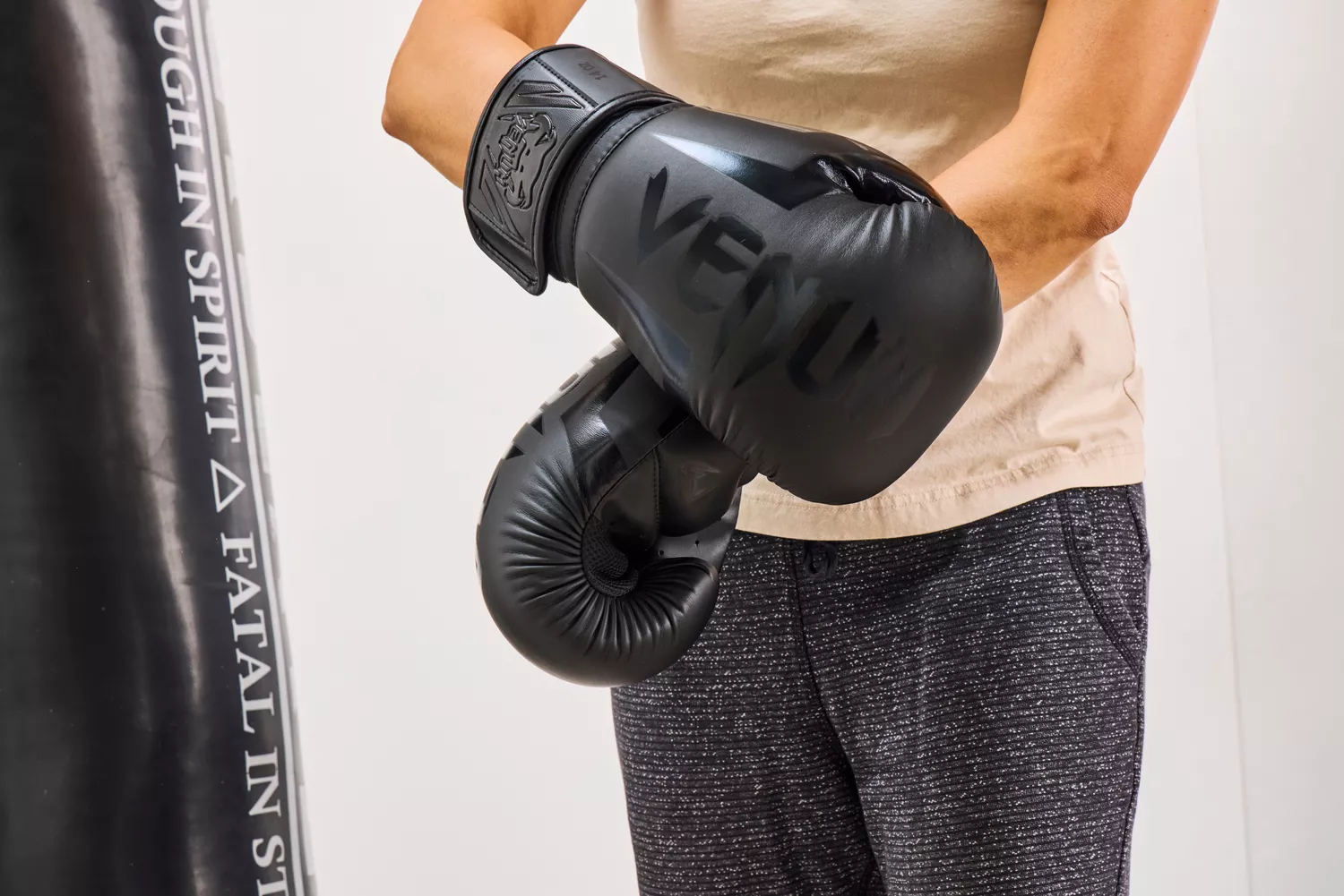 A person secures the Venum Elite Boxing Gloves 