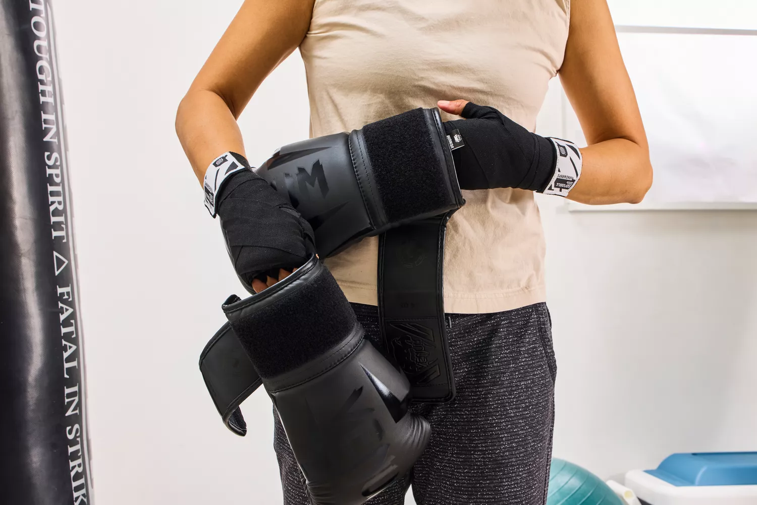 A person places the Venum Elite Boxing Gloves on their hands