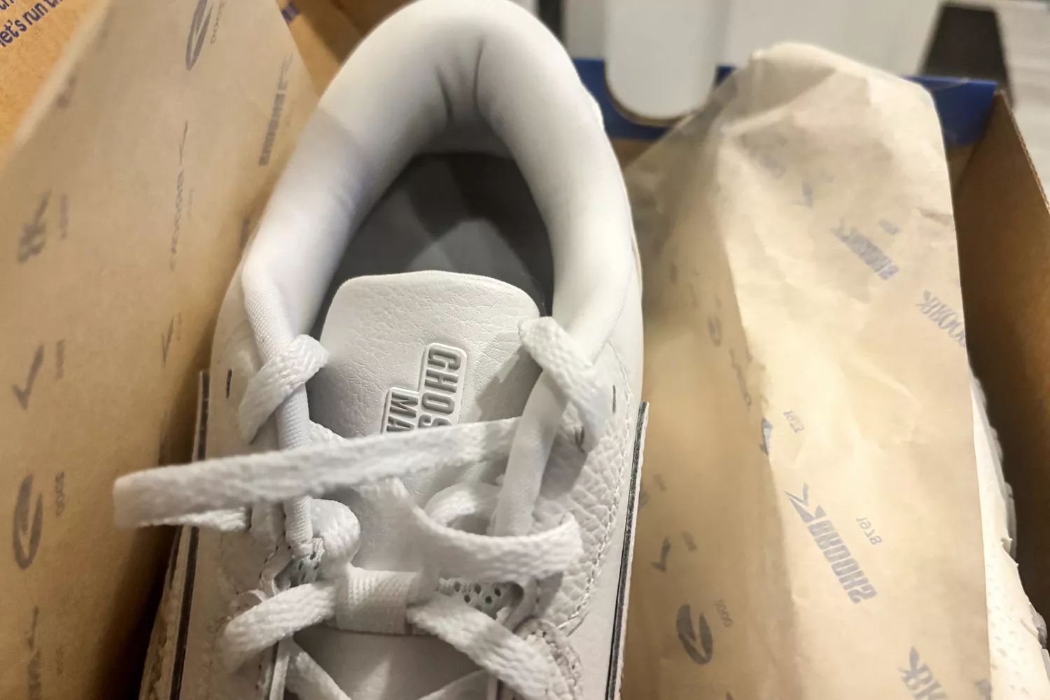 A close-up of a Brooks Men's Ghost Max L Sneaker in the box