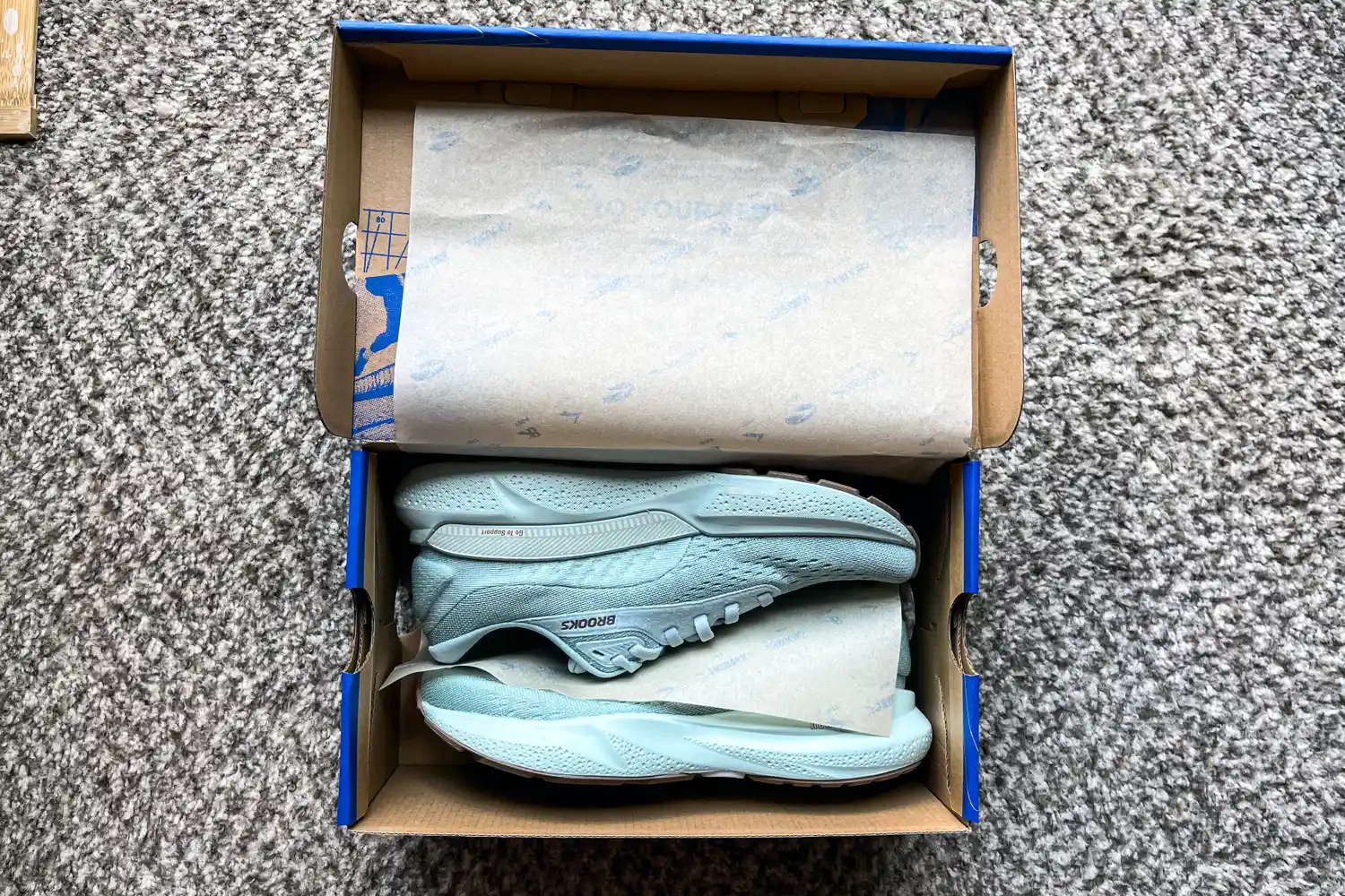 A pair of Brooks Women's Adrenaline GTS 24 Running Shoes in a shoebox with tissue paper