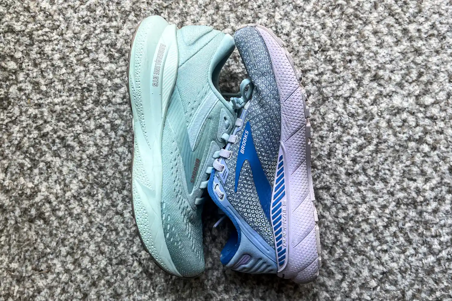 The Brooks Women's Adrenaline GTS 24 Running Shoe next to a different Brooks sneaker