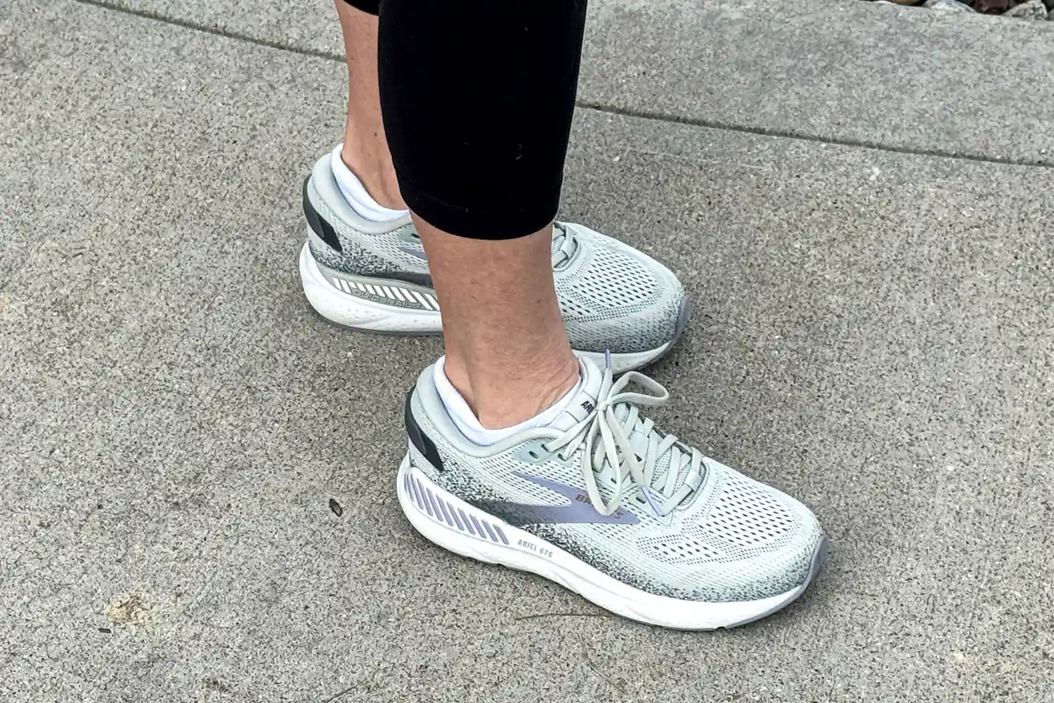 A side view of a person wearing the Brooks Women's Ariel GTS 24 Running Shoes